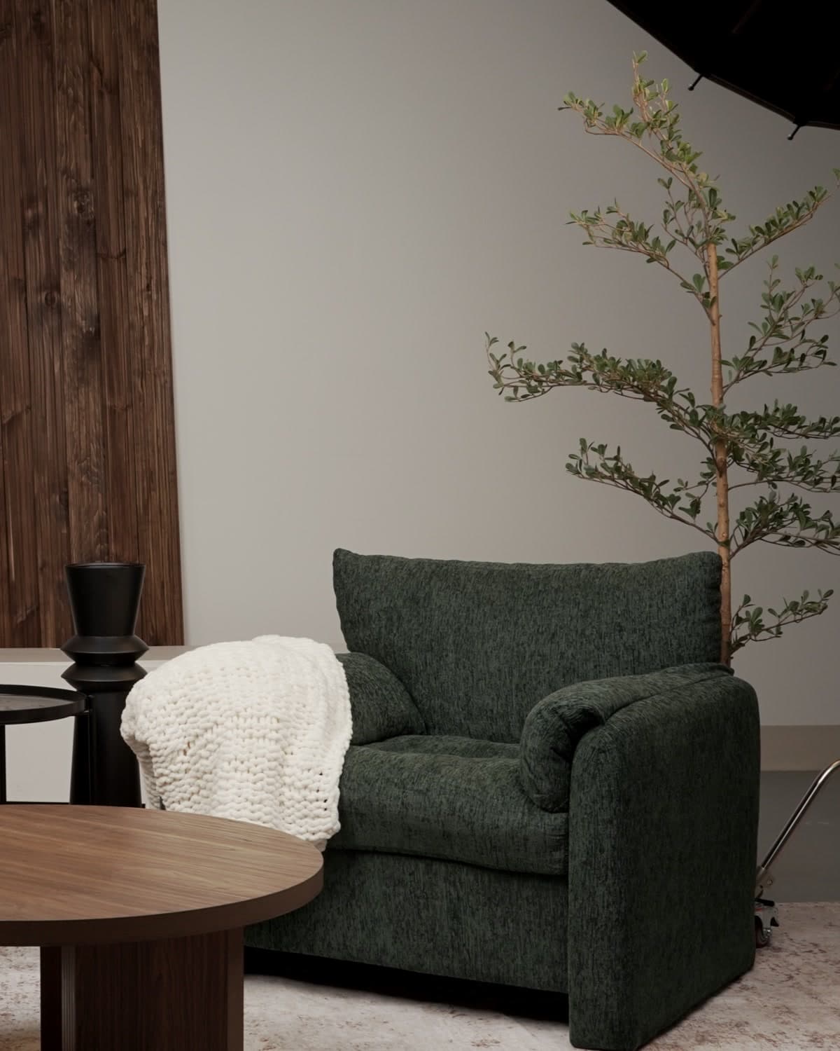 Content Suite — warm lounge seating with set wall and greenery